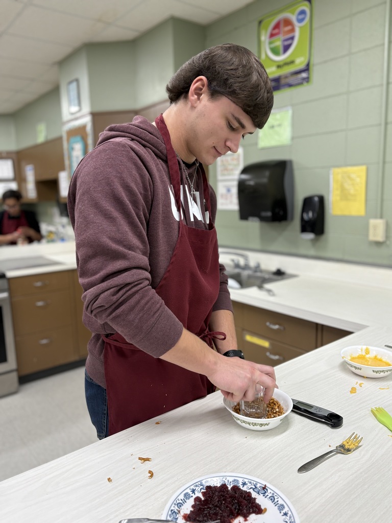 A high school student preparing a meal.