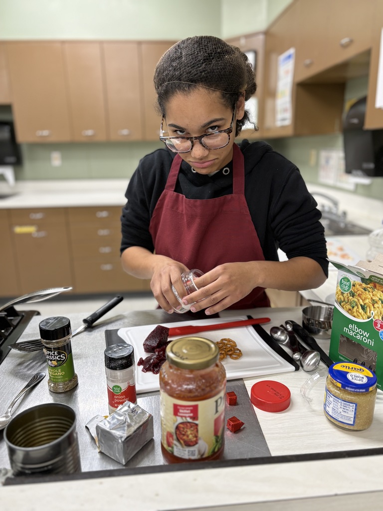 A high school student preparing a meal.