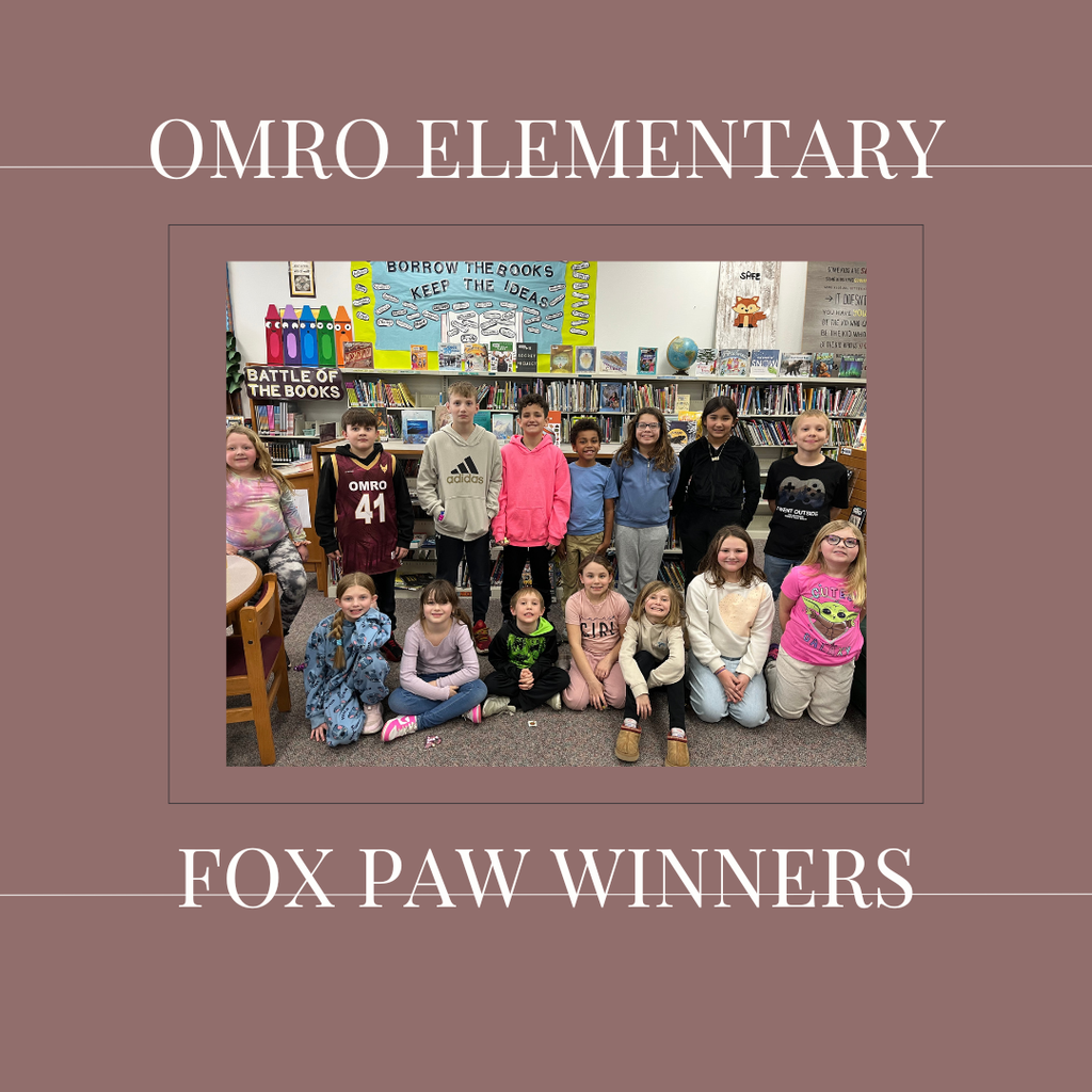 A group of elementary students standing in a media center.