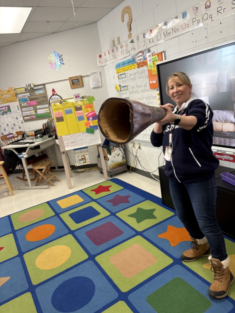 Guest speaker holding an instrument native to Australia.