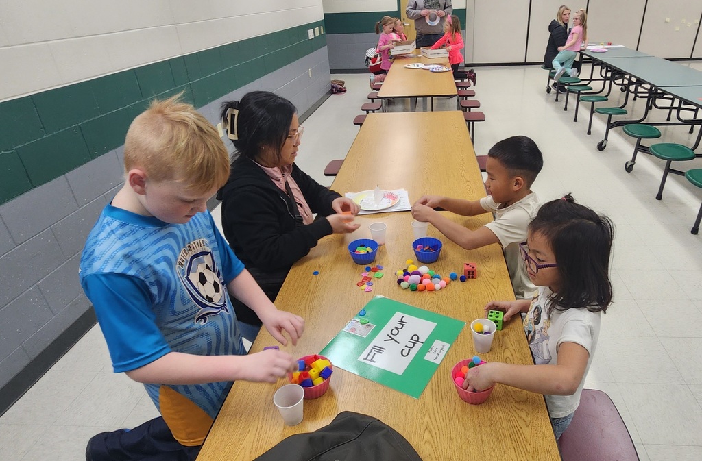 Families working together at a family night station.
