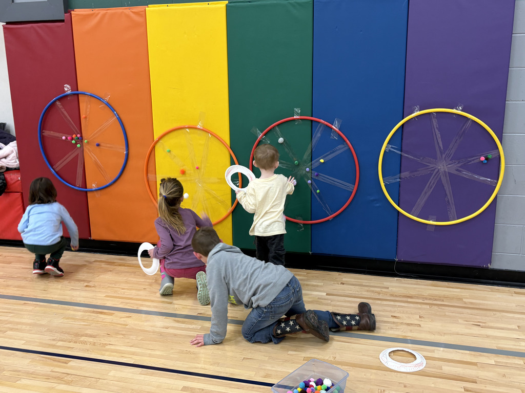 Hoola hoops taped to a wall that are used for target practice for young elementary schools to throw soft objects at.