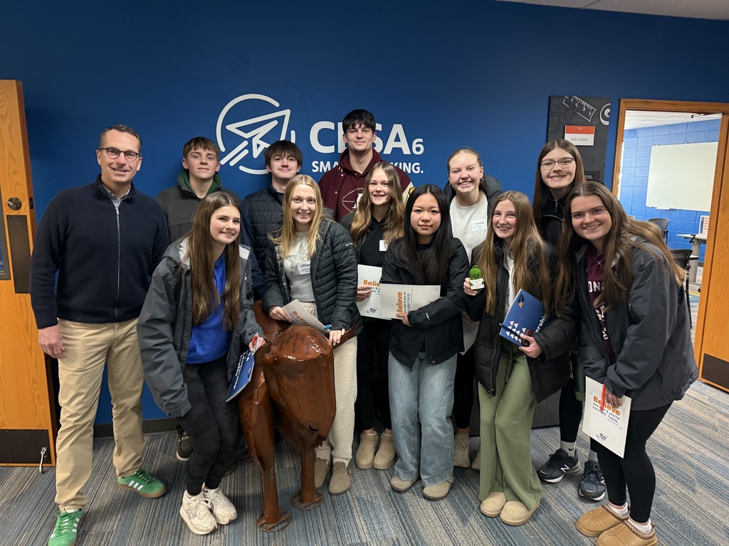 A group of high school students stands with CESA 6 CEO Ted Neitzke in front of a wall with the CESA 6 logo.