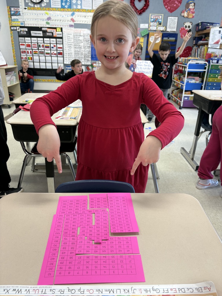 Student showing off a completed puzzle. 