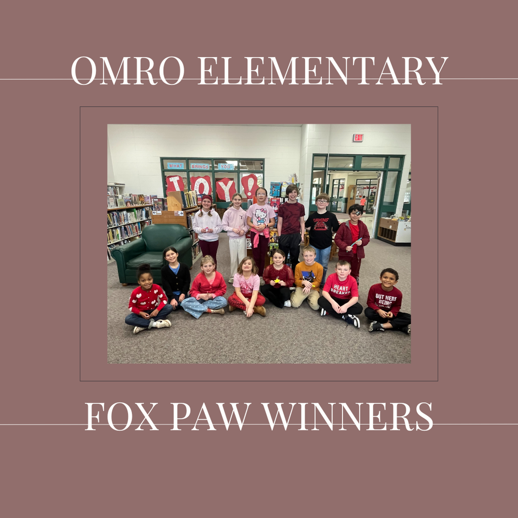 A group of elementary students standing in a media center.