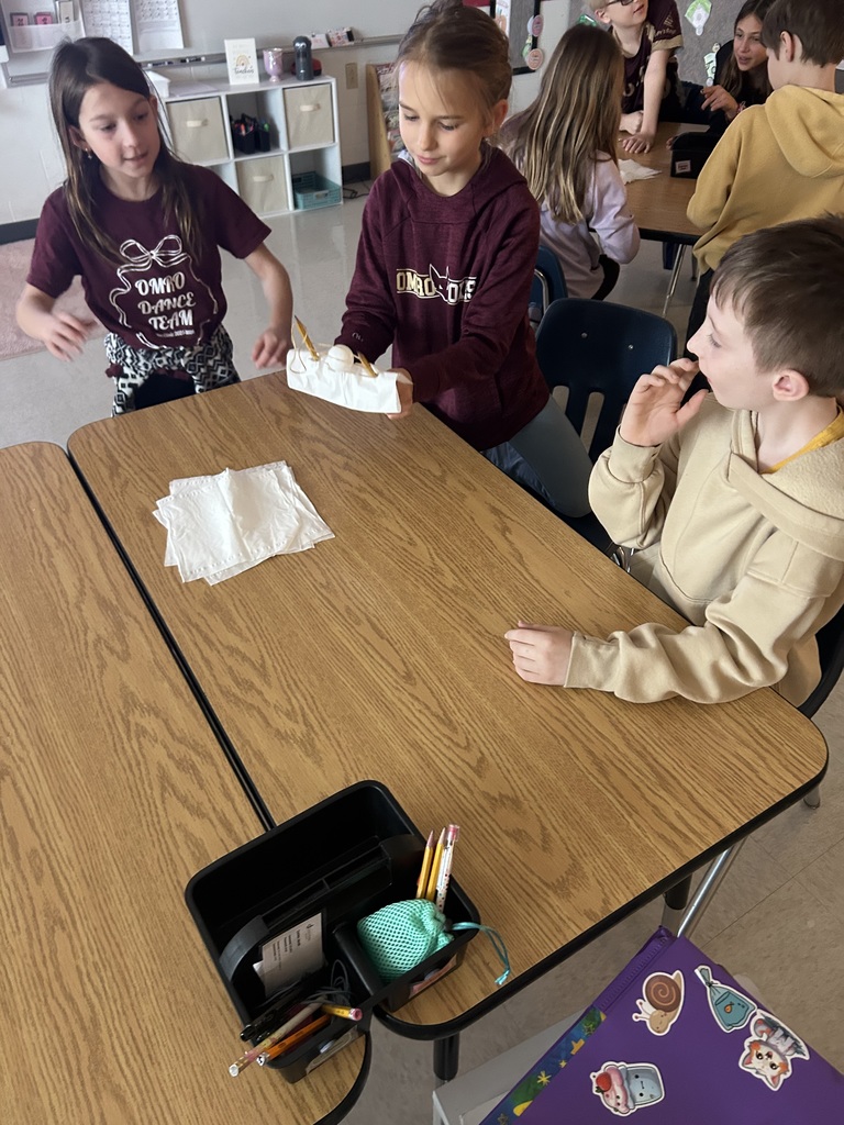 Elementary students collaborating with one another.