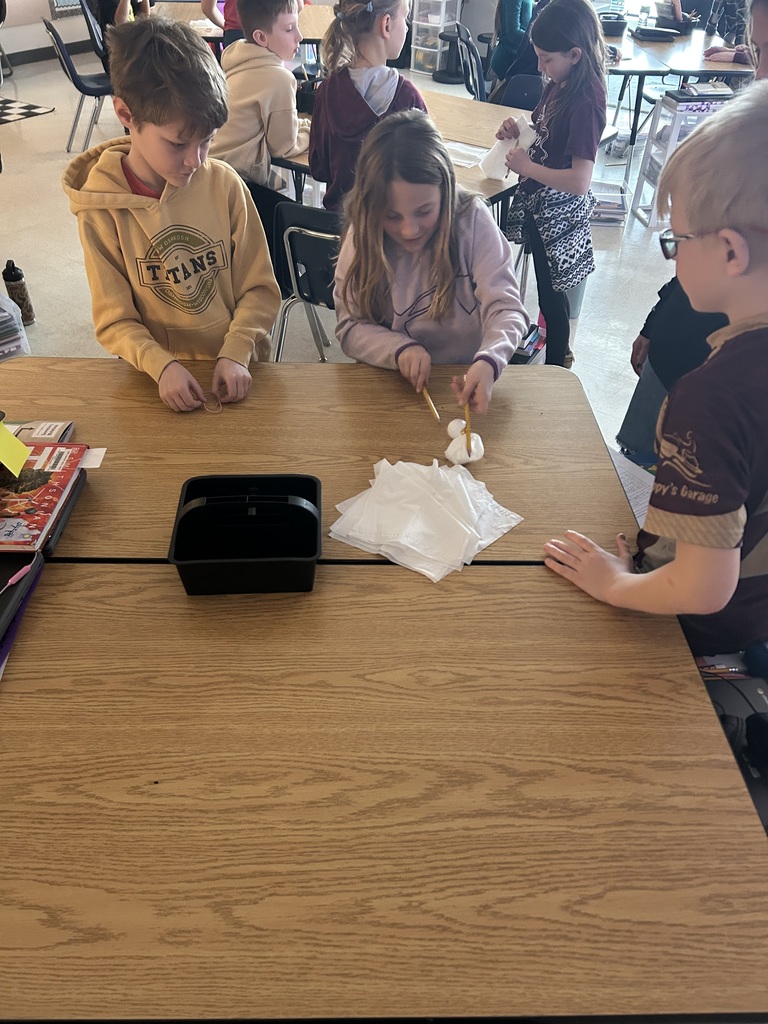 Elementary students collaborating with one another.