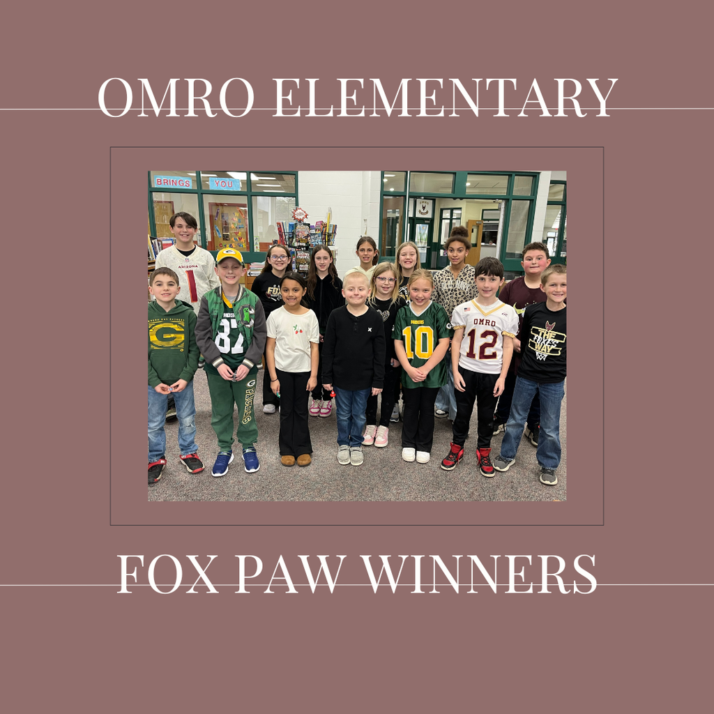 A group of elementary students standing in a media center.