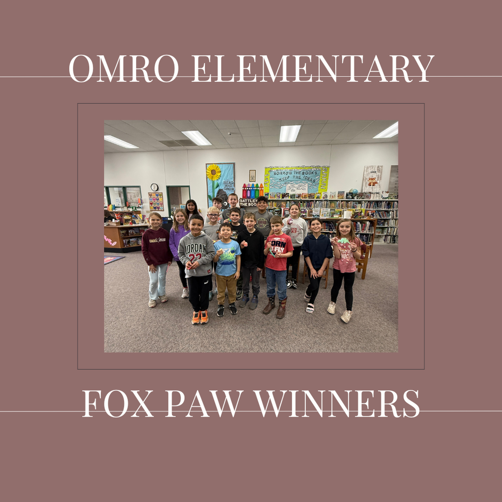 A group of elementary students standing in a media center.