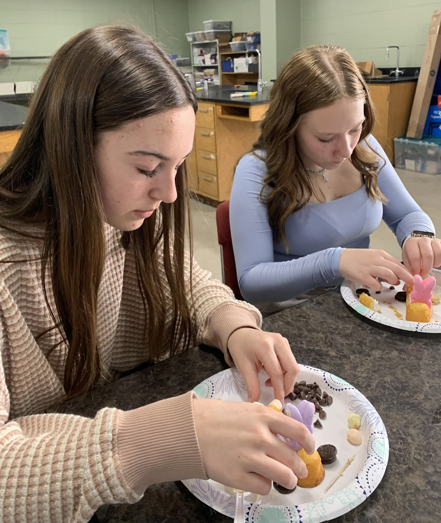 Two middle school students working on a food creation.