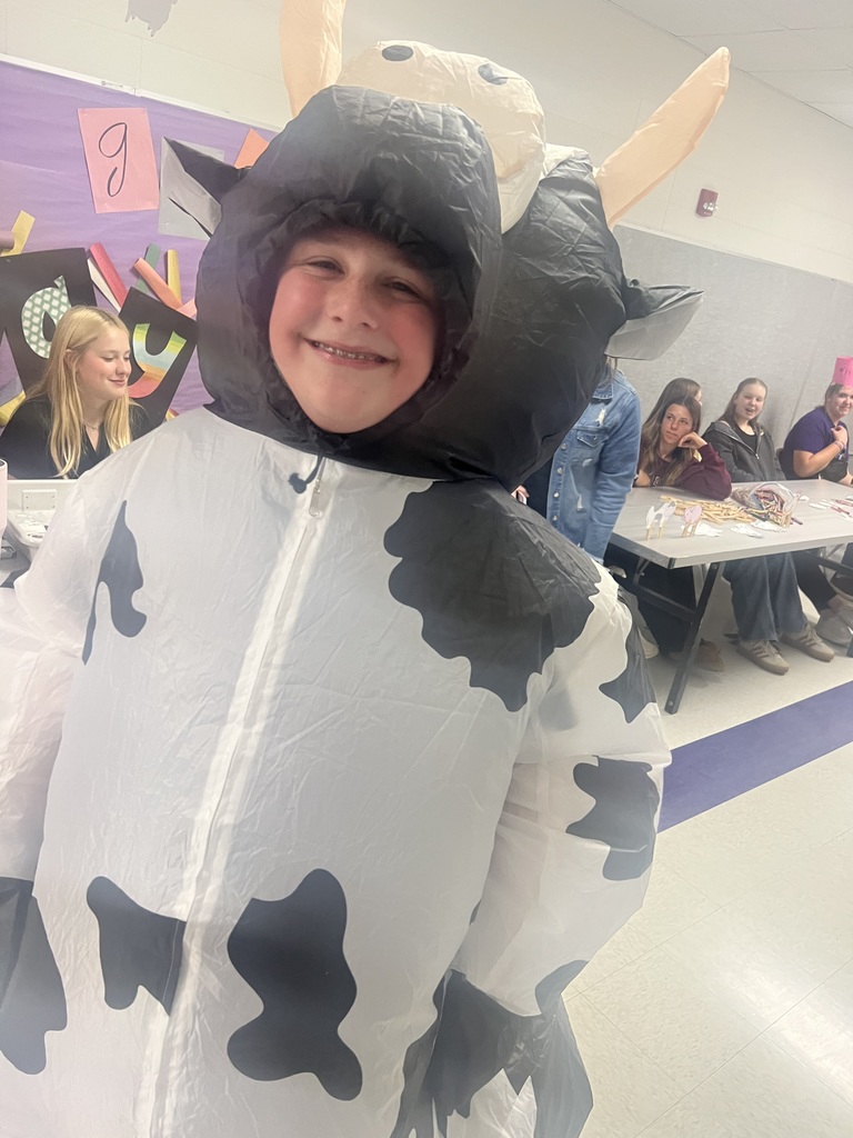 Middle school student dressed in a blow up cow costume.