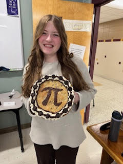 High school student holding a cookie pie.