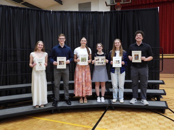 Six high school students holding certificates in front of them.