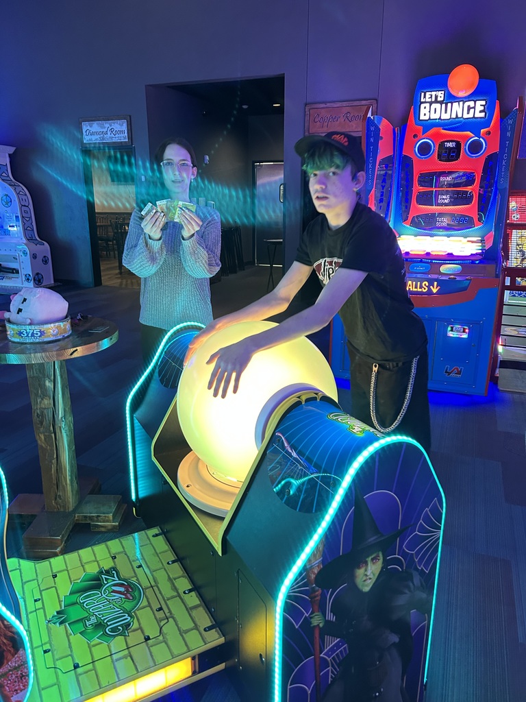 Two high school students at an arcade.