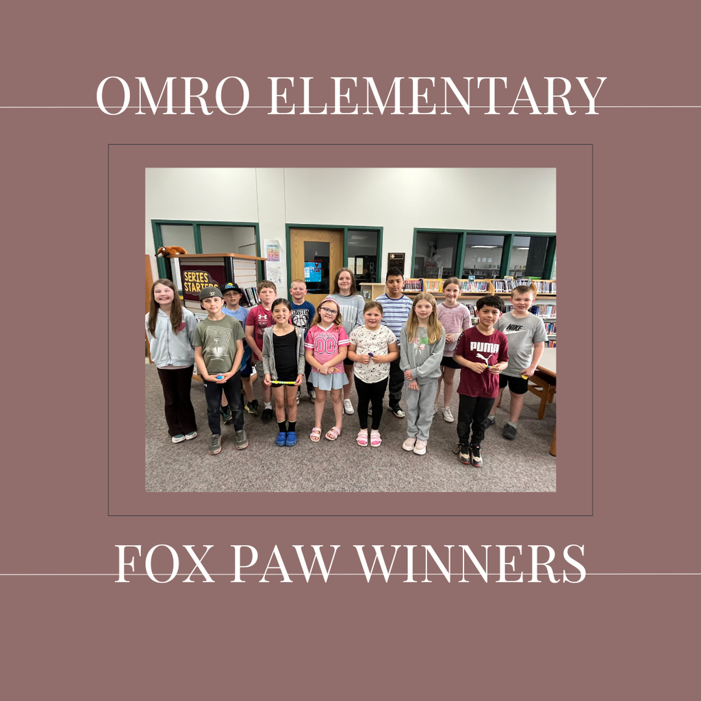 A group of elementary students standing in a media center.