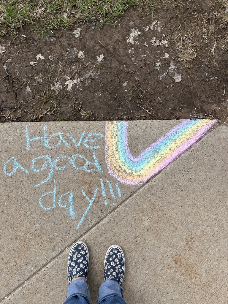 Two shoes pointing at sidewalk art that says, "Have a good day."
