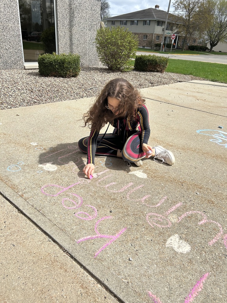 High school student doing sidewalk chalk art.