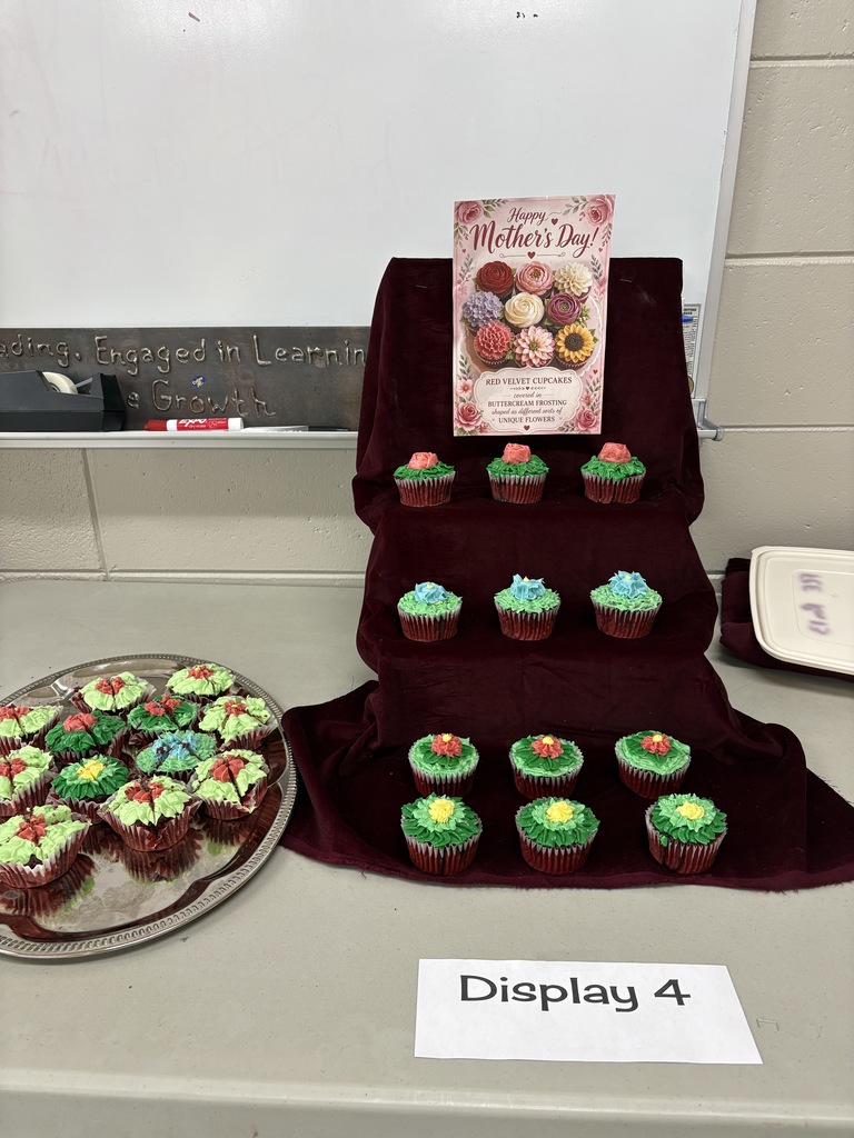 Cupcake display with cupcakes on a tiered display as well as a platter.