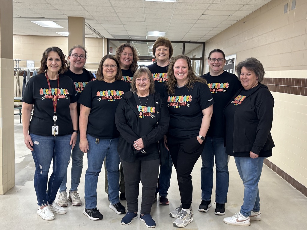 9 staff members wearing Autism acceptance t-shirts.