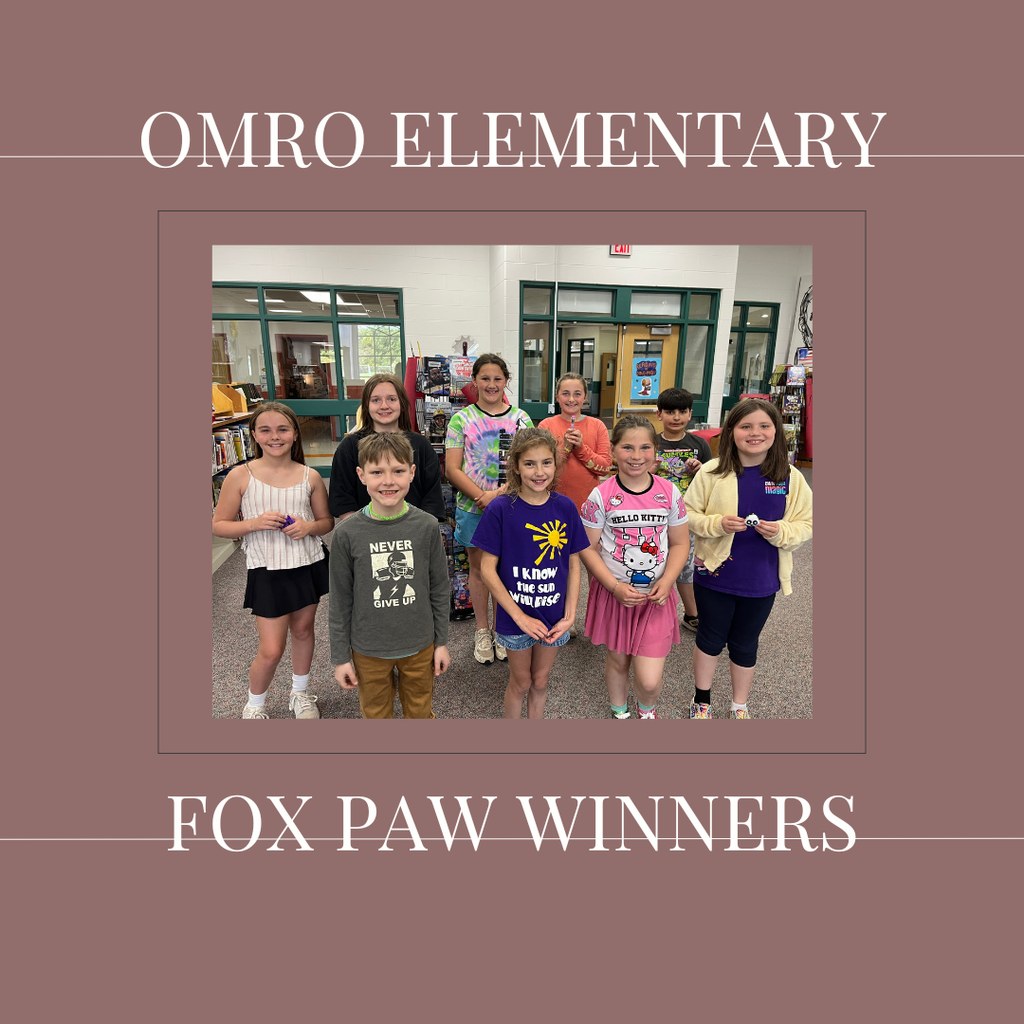 A group of elementary students standing in a media center.