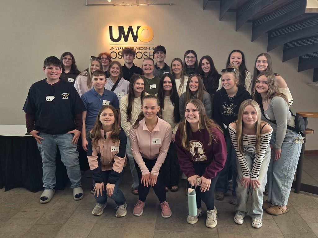 A group of high school students huddled together.