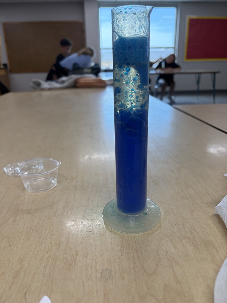 A test tube that has blue lava lamp liquid in it.