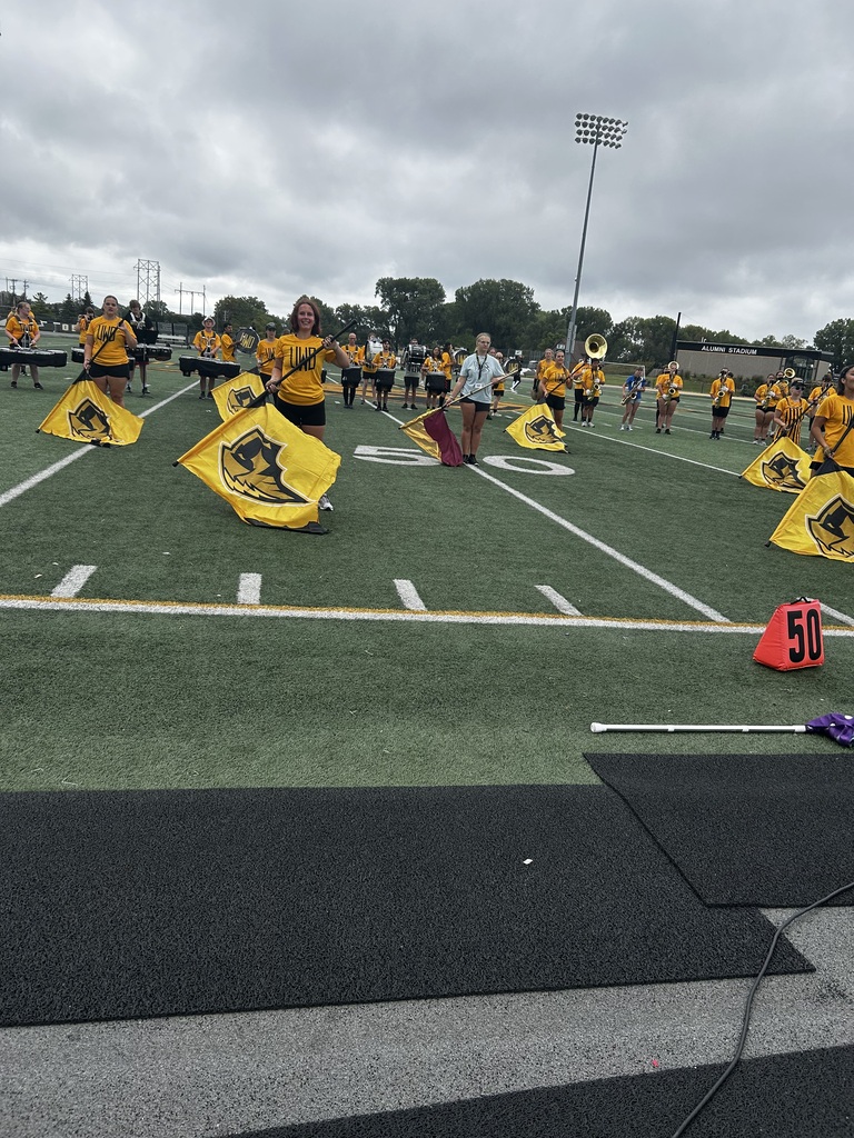 Color guard practicing on a football field. 