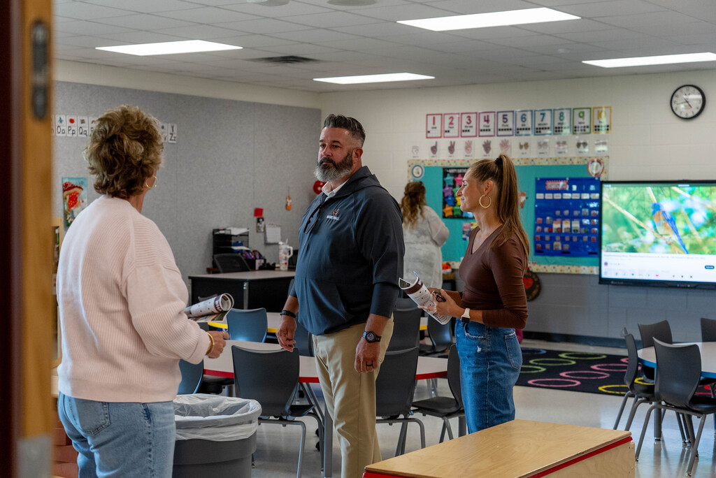 Adults viewing an early learning center classroom.