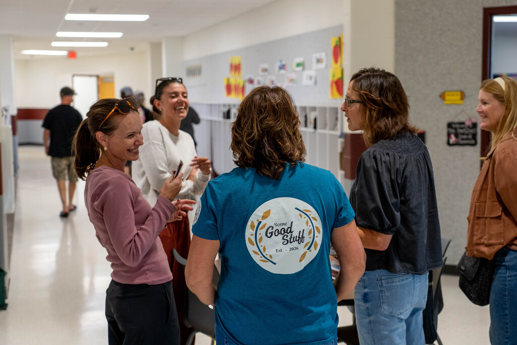 Adults enjoying a learning space, smiling and laughing with one another.