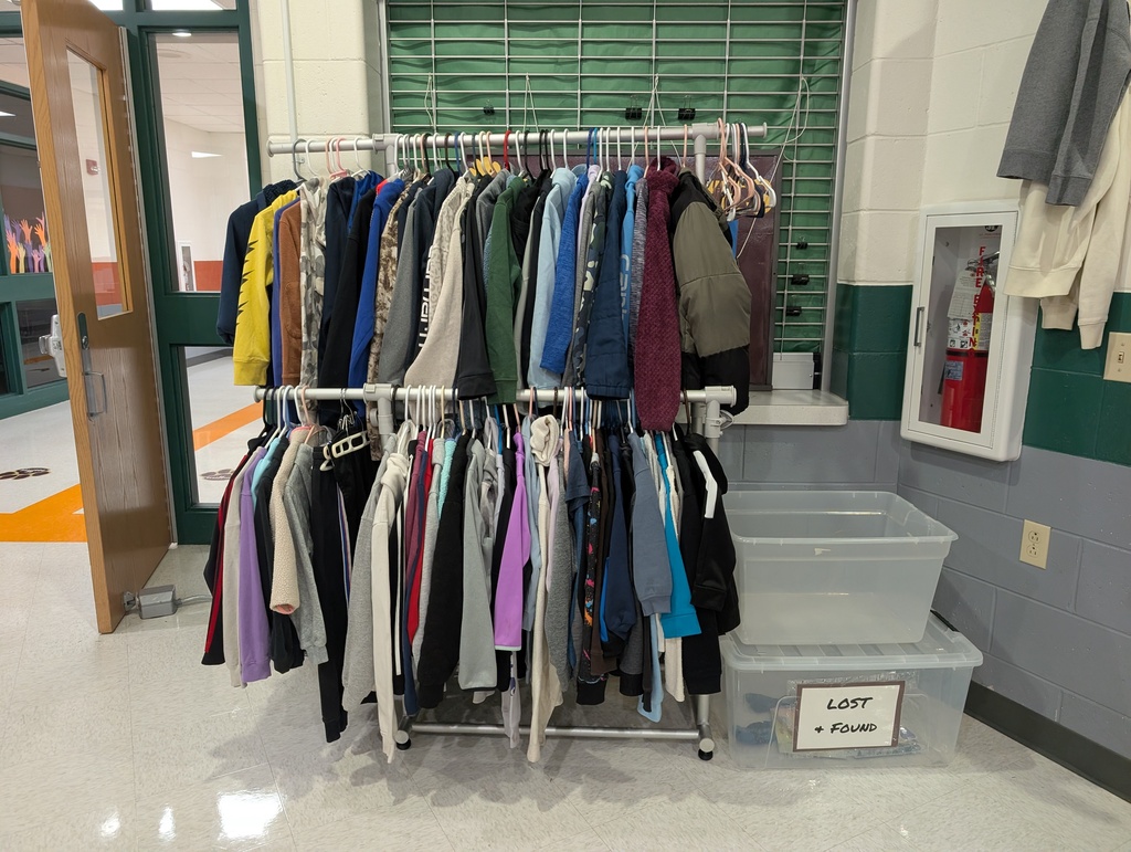Jackets and sweatshirts hung up on a rack as a Lost and Found.
