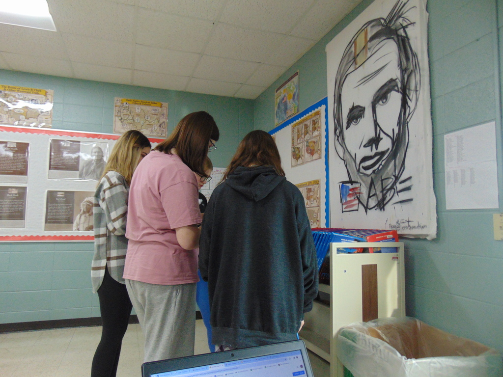 A group of students working together to solve an Escape Room.