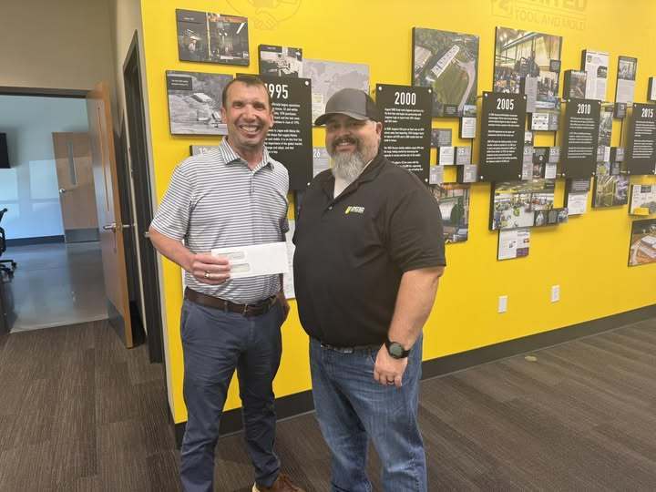 Tim Johnson, Director of G2i and Chad LaMance, Vice President of United Tool & Mold posing with donation check