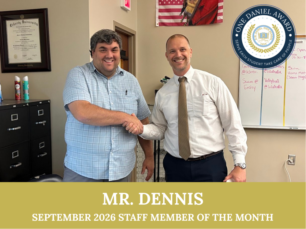 Mr. Dennis accepting his award from Mr. Russell.