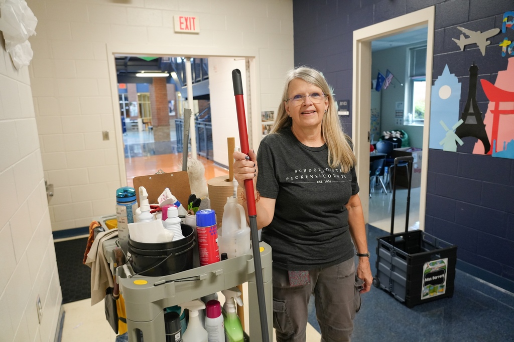 SDPC Custodian with cleaning cart and mop