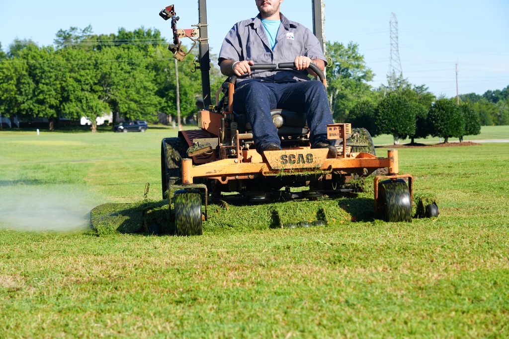 SDPC Grounds Crew member cutting grass