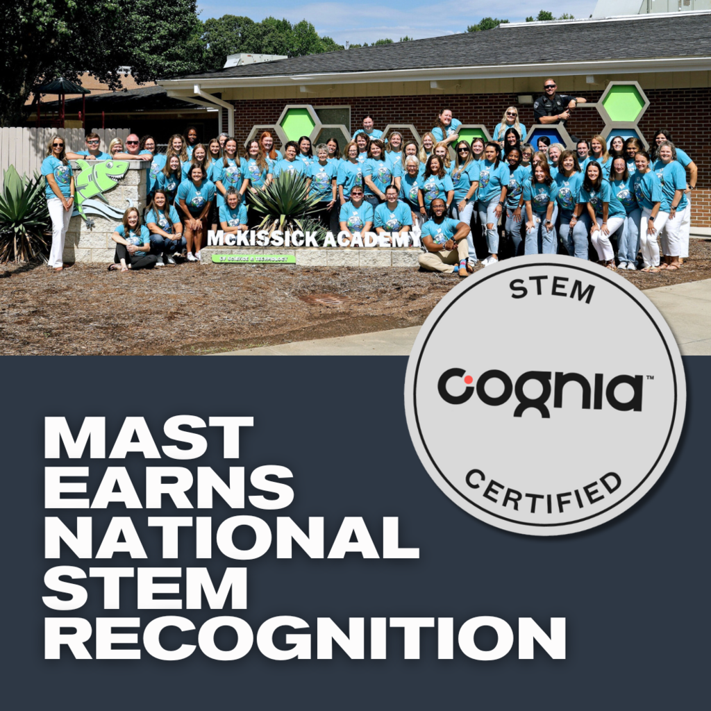 MAST Earns National STEM Recognition, MAST staff in front of school sign