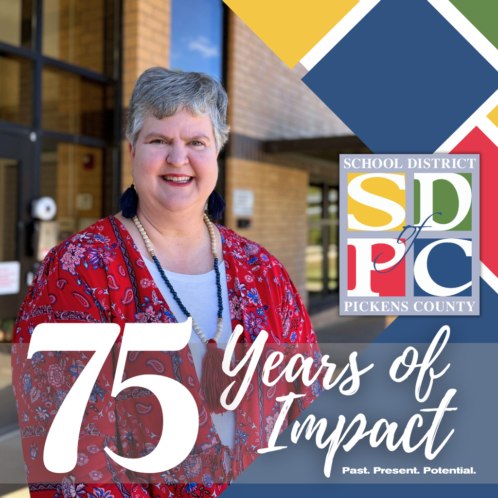 Teacher standing in front of school building