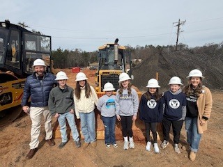 PMS, HES and Ambler students in front of bulldozer on G2i Site
