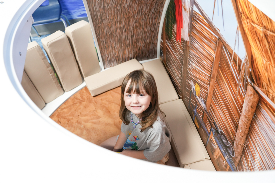 Grand Opening of SDPC Academy for Early Learners: student in "tent" in camping themed classroom