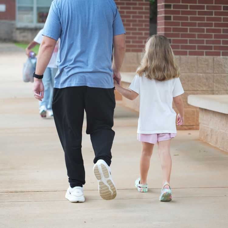 dad and child hand in hand during morning arrival