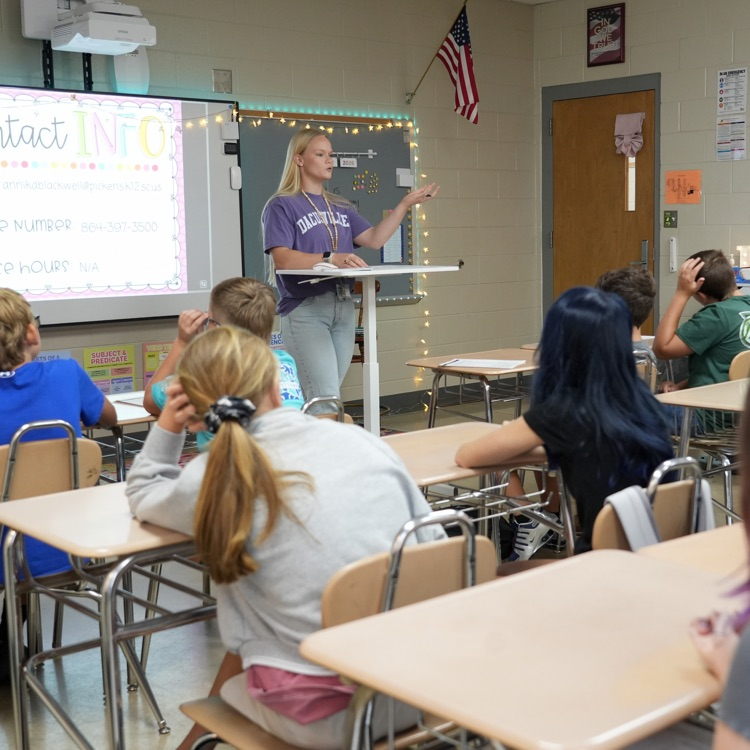 teacher speaking in front of students