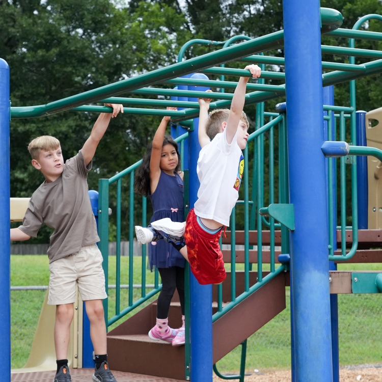 student on monkey bars