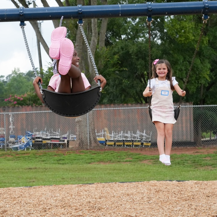 students swinging at recess