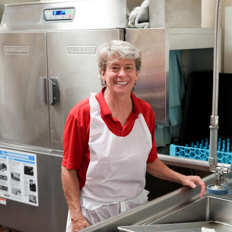 cafeteria worker washing dishes