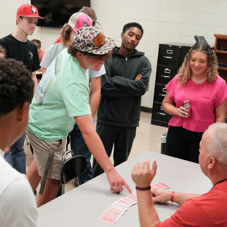 students playing cards with teacher during a math lesson