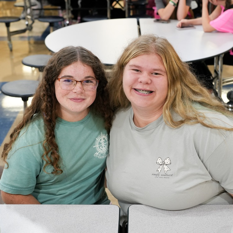 two new friends, smiling at lunch