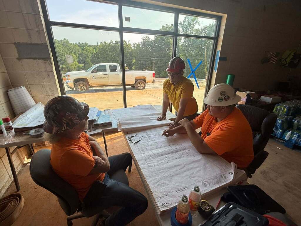 Alex Lay, Tim Franklin, Lane Towery having a discussion around construction documents at G2i