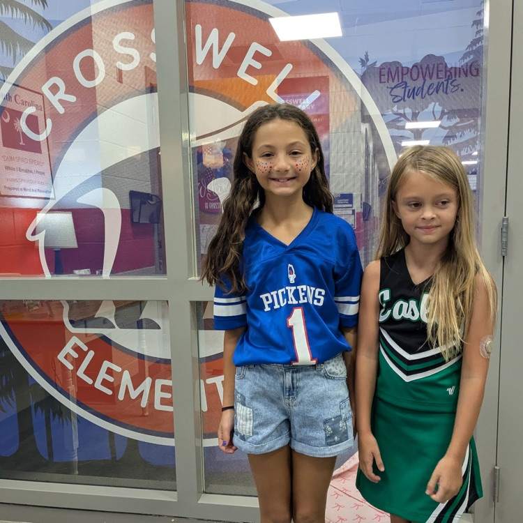 2 students model their school gear