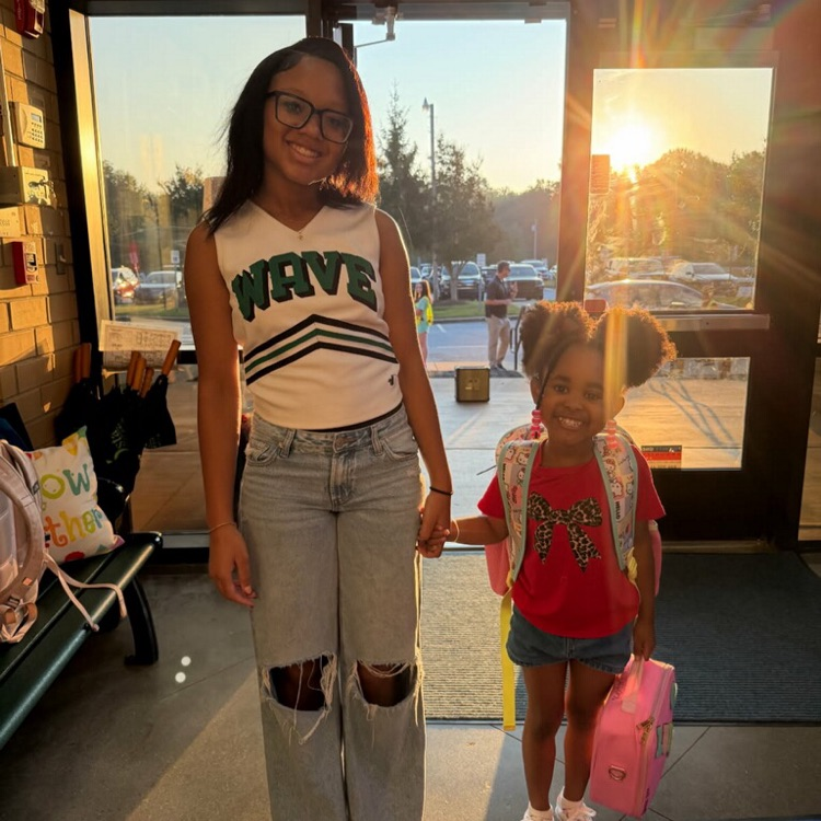 EHS cheerleader walks student to class