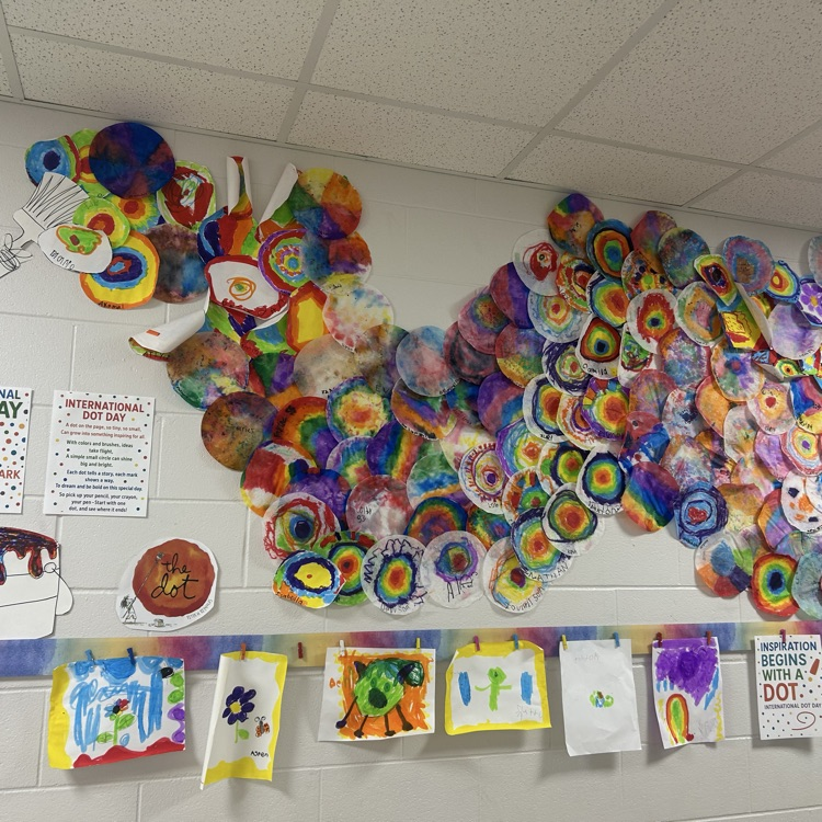 International Dot Day display created by Mrs. Ward’s art students, featuring hundreds of colorful painted dots flowing from a large paper paintbrush and paint can.